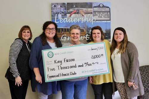 Kay poses with the Clay branch employees.