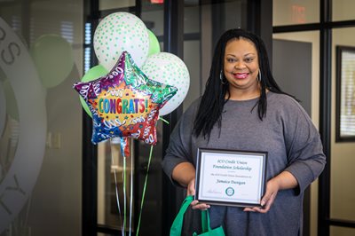 Jamaica Dunigan poses with her eCO Credit Union Foundation Scholarship certificate.