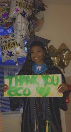 Scholarship recipient, Kristen Jones, displays a thank you sign.